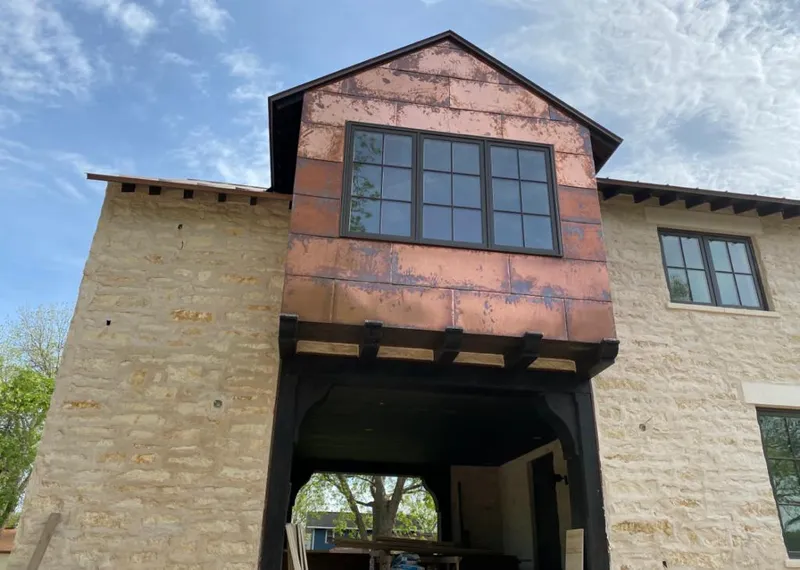 Copper metal panel facade on a stone building for Skylight Installation in Kingsville