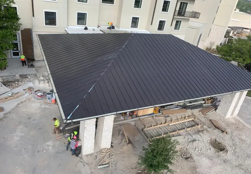 Metal roofing installation team working on a commercial building in Kingsville